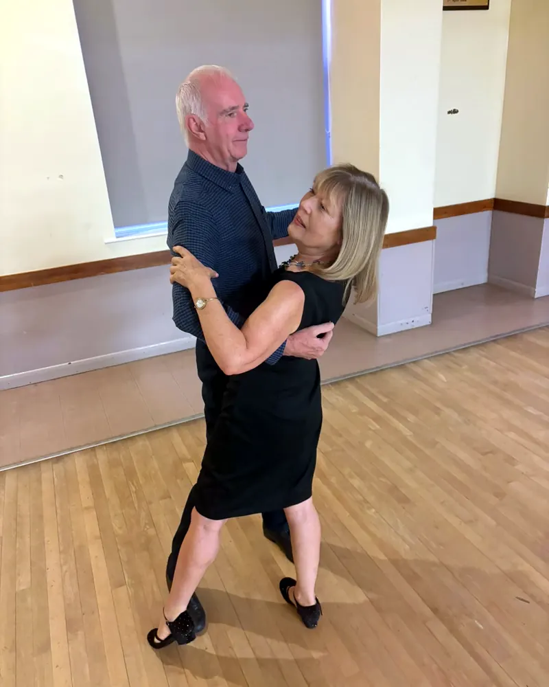Two of Justyna's students in a ballroom hold