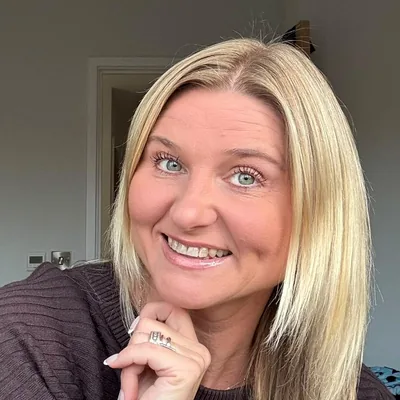 Justyna Wells smiling, resting her chin on her hand